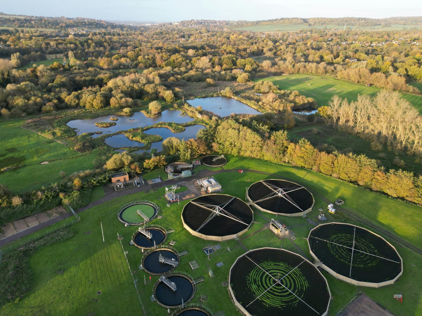 Home Drone shot of a picturesque rural water treatment plant surrounded by nature.